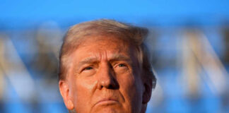 Close-up portrait of a serious-looking political figure outdoors