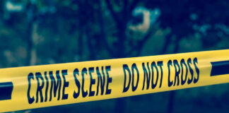 Yellow crime scene tape reading DO NOT CROSS