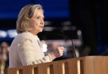 A woman speaking at a podium with a microphone during a public event