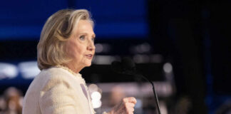 A woman speaking at a podium with a microphone during a public event