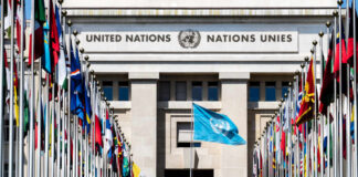 United Nations building with multiple international flags in front