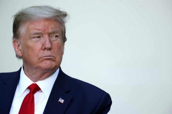 shutterstock2566586537-1jpg A serious-looking man in formal attire with an American flag pin