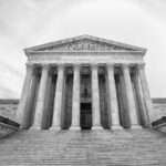 Front view of the Supreme Court building with columns and statues
