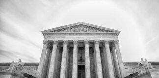 Front view of the Supreme Court building with columns and statues