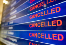 Airport departure board showing multiple flights marked as cancelled