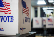 Voting booths with American flags in a polling station