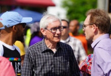 A diverse group of people engaged in conversation outdoors