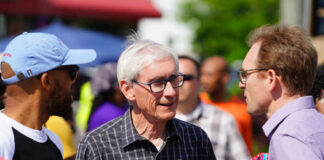 A diverse group of people engaged in conversation outdoors