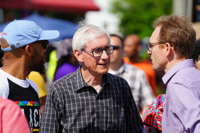 A diverse group of people engaged in conversation outdoors