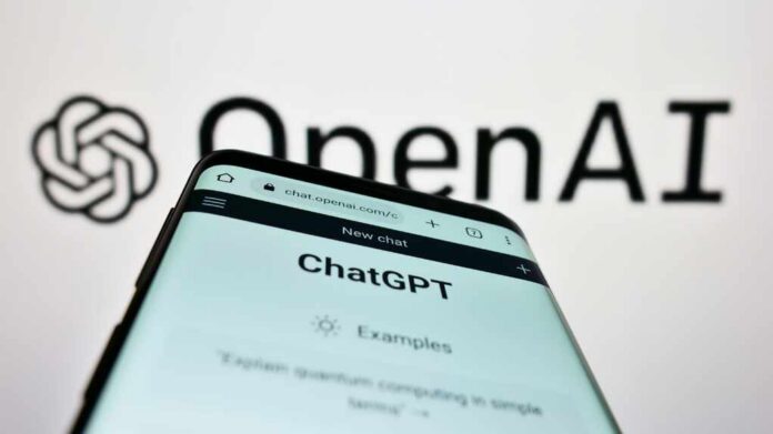 Close-up of a smartphone displaying the ChatGPT interface with the OpenAI logo in the background
