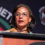 A woman speaking at a podium during a conference