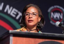 A woman speaking at a podium during a conference
