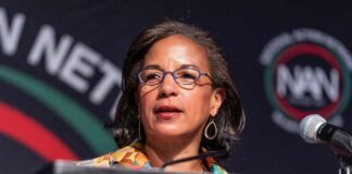 A woman speaking at a podium during a conference