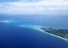 Aerial view of a tropical island surrounded by blue ocean waters