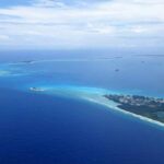 Aerial view of a tropical island surrounded by blue ocean waters