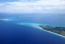 Aerial view of a tropical island surrounded by blue ocean waters