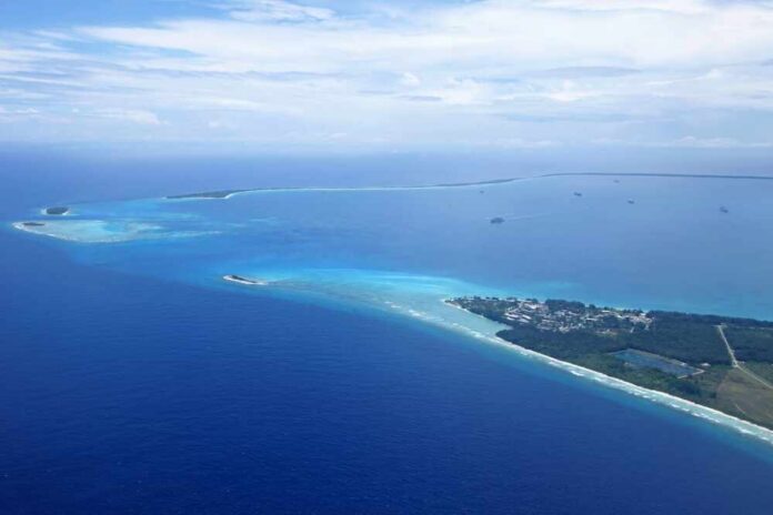 Aerial view of a tropical island surrounded by blue ocean waters