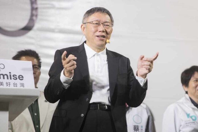 A speaker gestures while addressing an audience at a political event