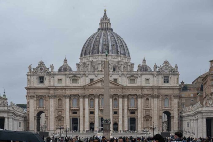 St. Peters Basilica in Vatican City with a cloudy sky and a large obelisk in the foreground