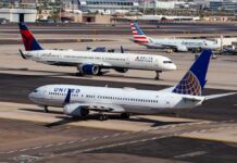 Three commercial airplanes on an airport runway