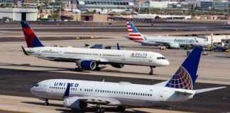 Three commercial airplanes on an airport runway