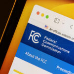 Close-up of the Federal Communications Commission website displayed on a screen
