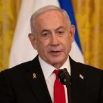 A government official speaking at a podium with a microphone