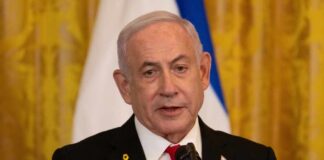 A government official speaking at a podium with a microphone