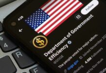 Close-up of a smartphone displaying a Twitter profile with an American flag