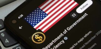 Close-up of a smartphone displaying a Twitter profile with an American flag