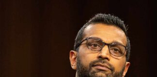 Individual in formal attire during a government hearing