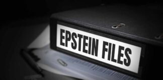 A black binder labeled 'Epstein Files' with papers and a pen beside it