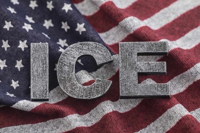 Letters 'ICE' placed on a background of an American flag