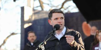 Individual speaking into a microphone at an outdoor event