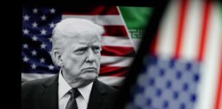 Donald Trump in front of an American flag, displaying a serious expression