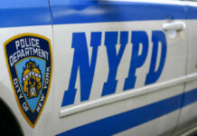 Close-up of a New York Police Department vehicle with badge and NYPD lettering
