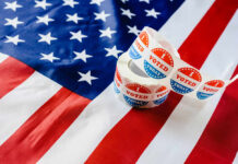 Voting stickers on an American flag background