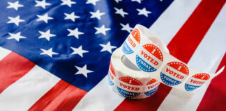 Voting stickers on an American flag background