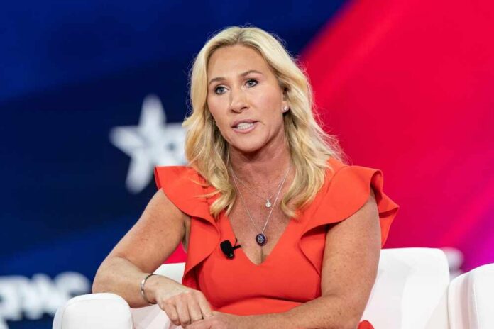 A woman in a red dress speaking at a conference