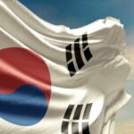 Waving flag of South Korea against a blue sky
