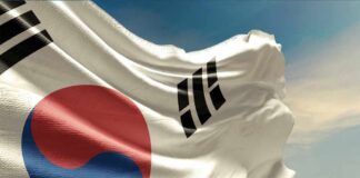 Waving flag of South Korea against a blue sky