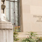Exterior view of the Department of Justice building with decorative elements