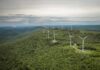 Aerial view of wind turbines on a green hillside