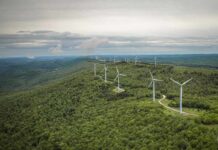 Aerial view of wind turbines on a green hillside