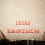 Typewritten text reading 'HUMAN TRAFFICKING' on paper
