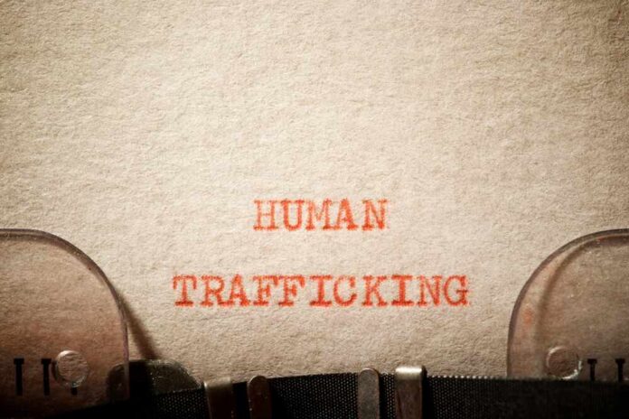 Typewritten text reading 'HUMAN TRAFFICKING' on paper