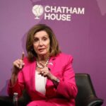 A woman in a pink suit speaking at a Chatham House event