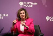A woman in a pink suit speaking at a Chatham House event