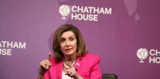 A woman in a pink suit speaking at a Chatham House event