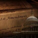 Close-up of the First Amendment text with the U.S. Capitol dome in the background